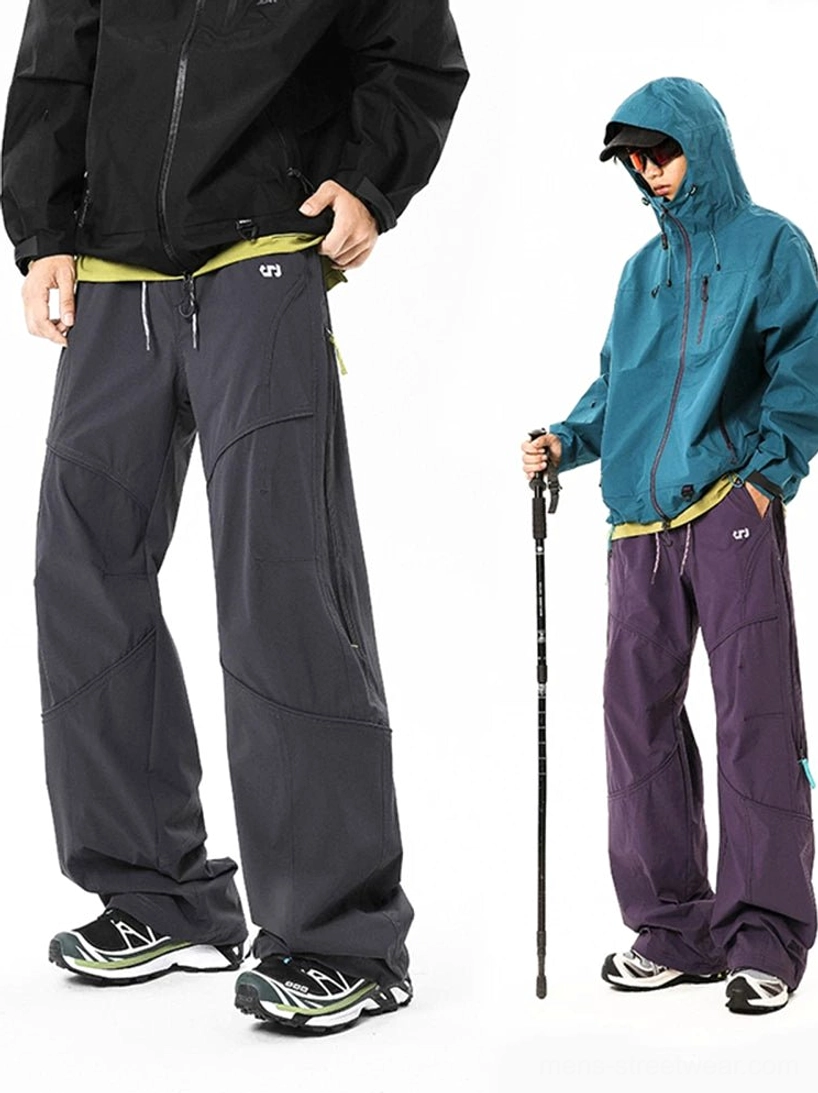 Gray and dark purple colorblock tech cargo pants shown from front and side angles with hiking-inspired styling