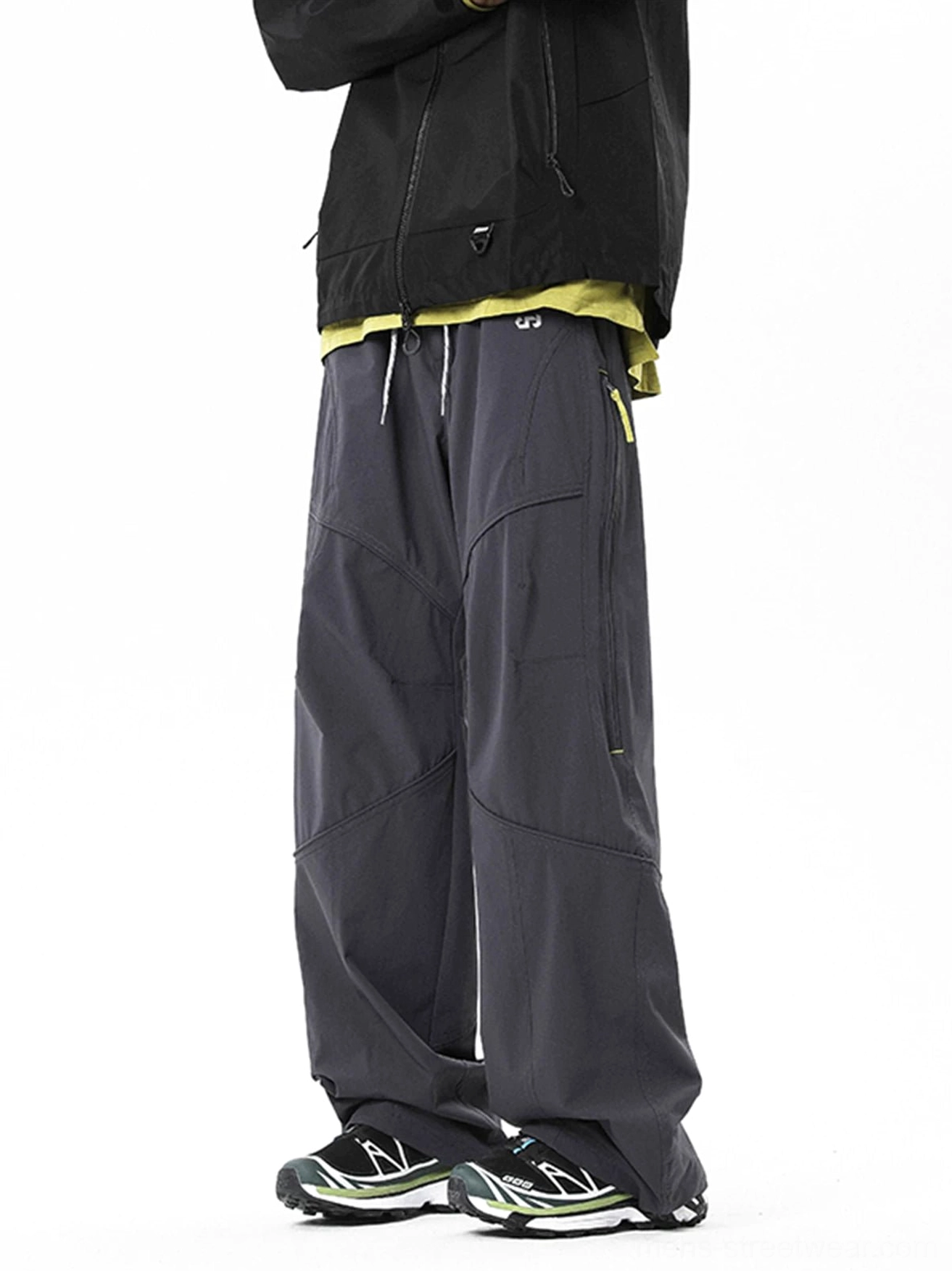 Dark gray relaxed wide-leg tech cargo pants with multi-panel stitching and drawcord waist in a Korean streetwear outfit