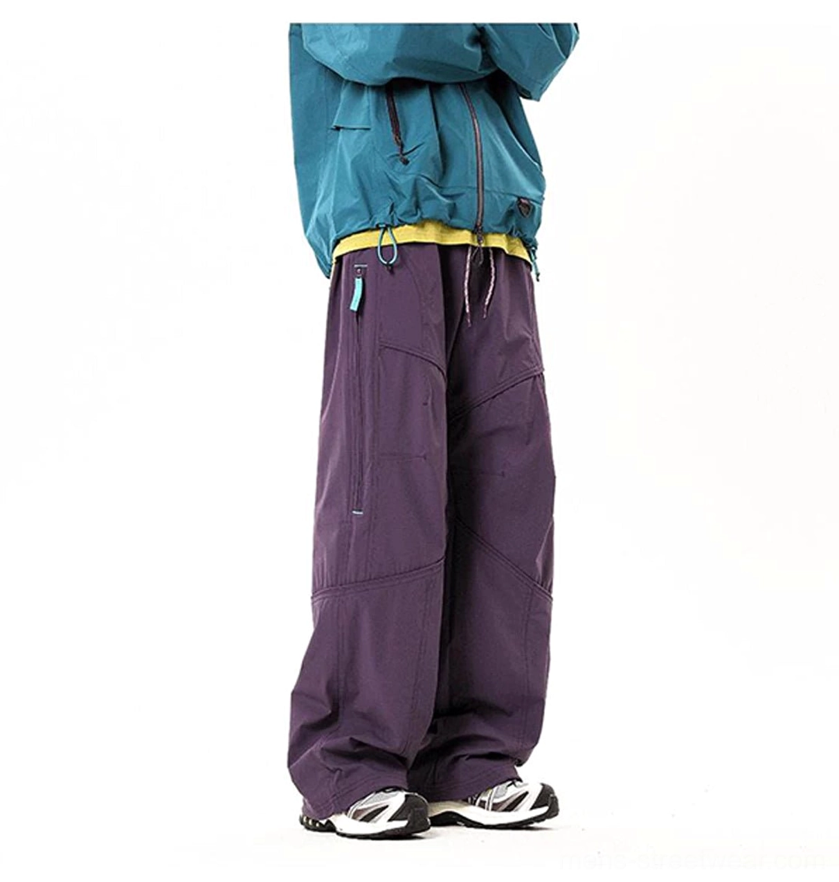 Dark purple wide-leg technical cargo pants shown from a rear side angle with curved seams and minimalist outdoor styling