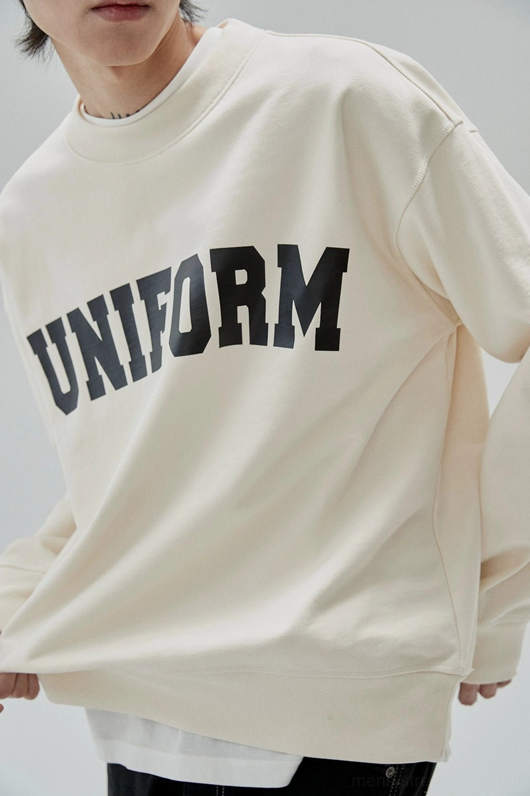 Contemporary relaxed sweatshirt blending collegiate nostalgia with modern East Asian streetwear