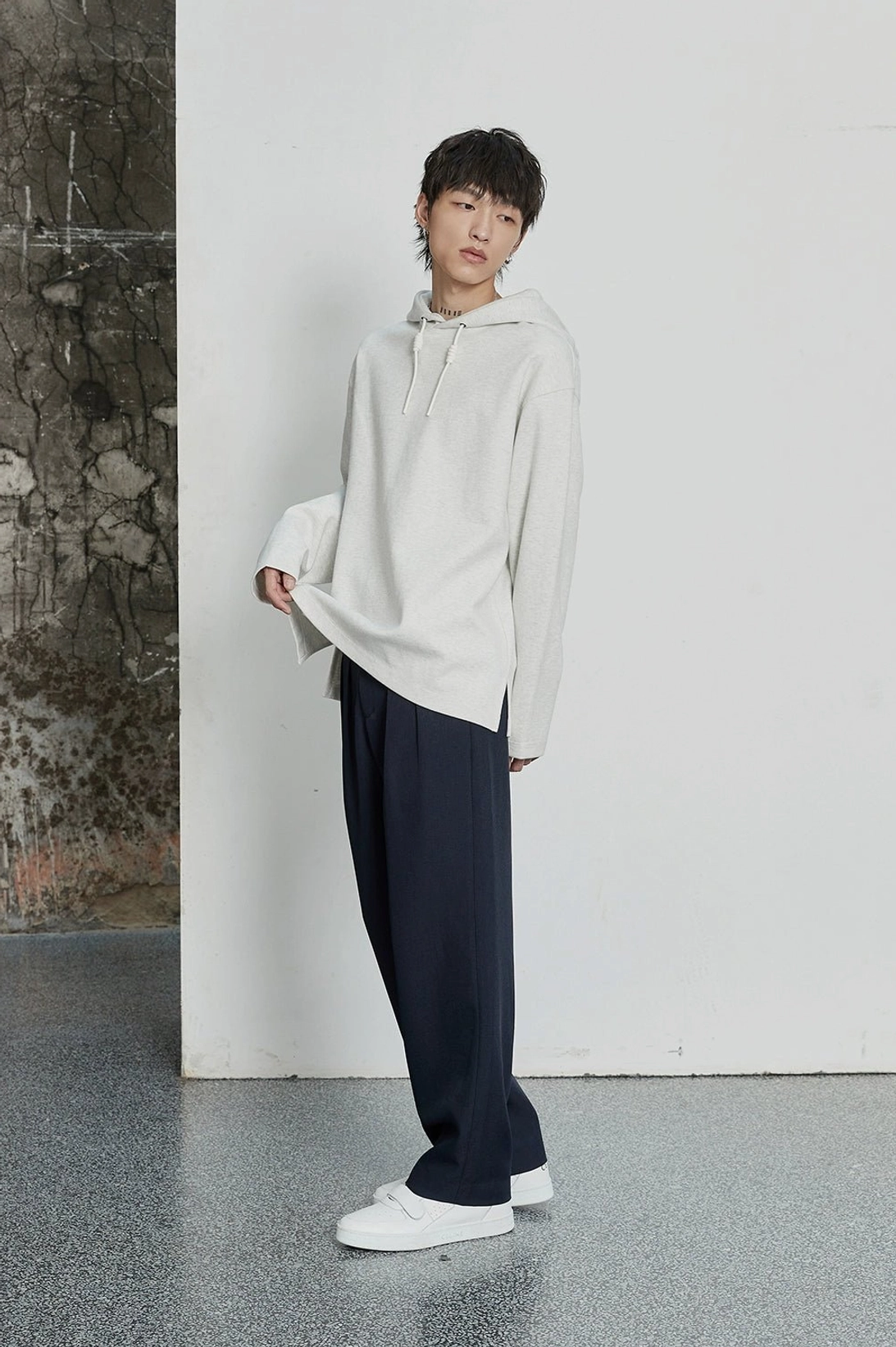 Contemporary smart casual pants with relaxed fit, hidden closure, and tailored pleats