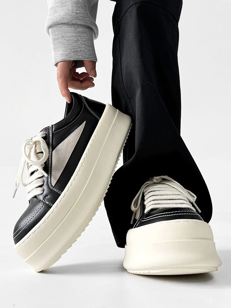 Contemporary streetwear platform sneakers with substantial sole and clean microfiber leather upper