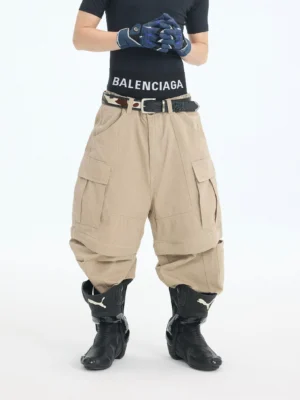 Front full-body view of khaki convertible zip-off cargo pants with wide-leg Korean streetwear fit, multiple utility pockets, belt loops, and detachable lower leg panels