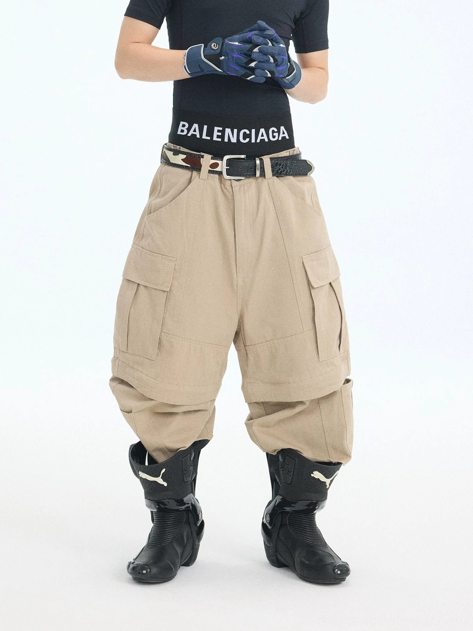 Front full-body view of khaki convertible zip-off cargo pants with wide-leg Korean streetwear fit, multiple utility pockets, belt loops, and detachable lower leg panels