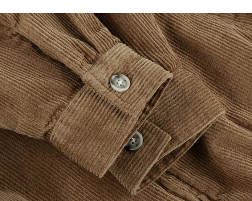 Close-up of corduroy Harrington jacket sleeve cuff with adjustable round buttons neat stitching and thick ribbed texture