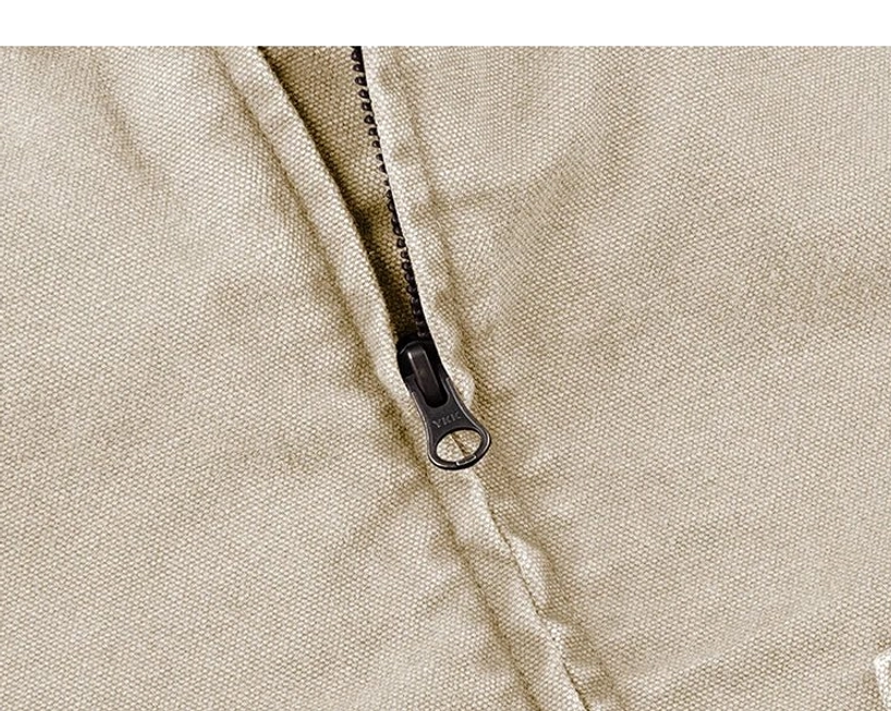 Close-up of durable cotton canvas work jacket front with metal zipper, D-ring pull tab, and precise stitched placket construction