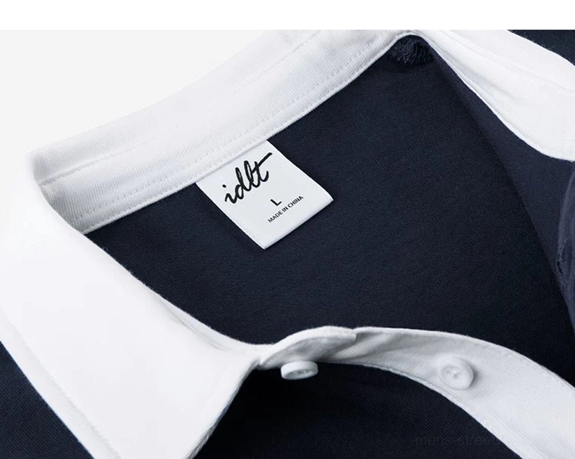 Interior collar detail of cotton knit polo shirt showing white collar lining and size label