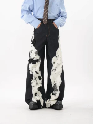 Front view of dark indigo cow print faux fur spliced wide leg denim trousers with high waist and relaxed streetwear fit