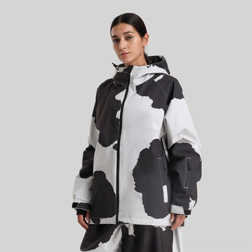 Cow print hooded ski jacket worn with matching patterned snow pants, showcasing bold contemporary Korean snowboard streetwear styling