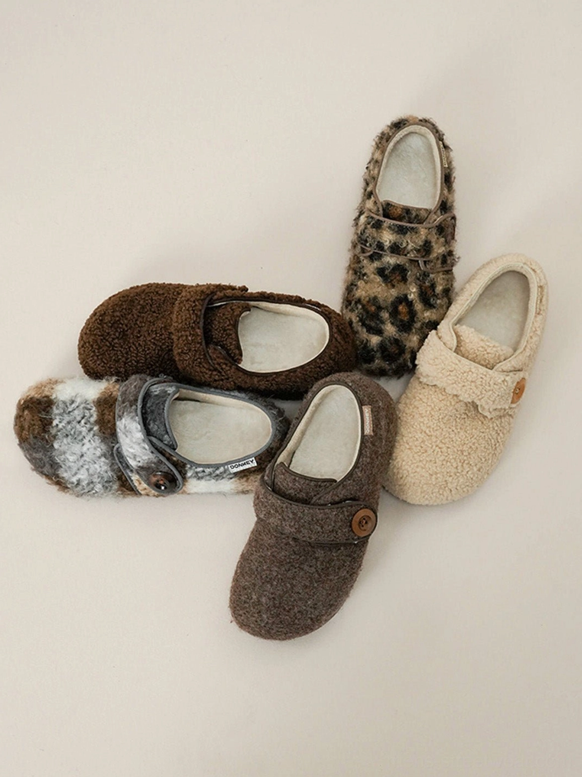 Cozy faux fur Velcro slip-on shoes with rounded toe and adjustable button strap