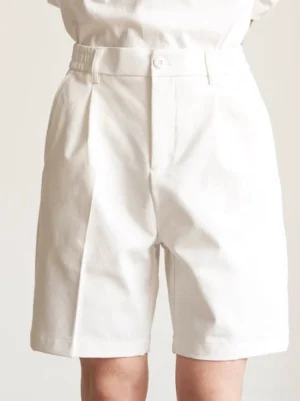 Front view of cream off-white tailored pleated shorts with relaxed straight leg, high-rise button waistband, single pleat, and minimalist Seoul fashion styling