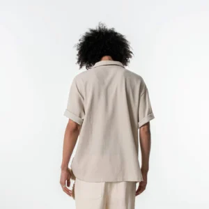 Back view of a relaxed cream waffle knit polo shirt with dropped shoulders and oversized Korean streetwear fit
