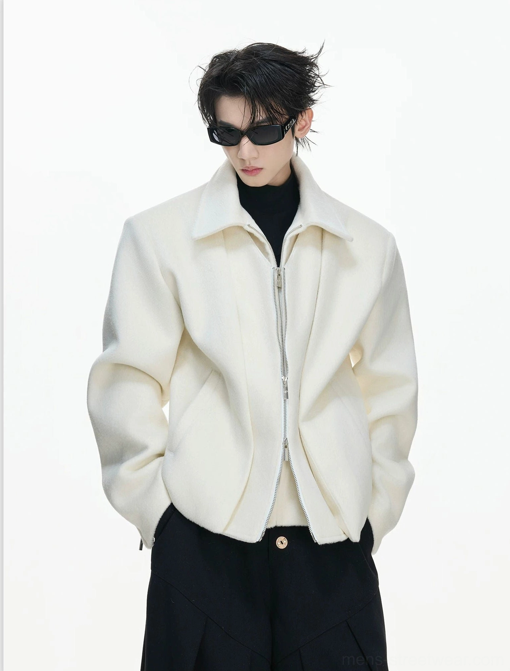 Three-quarter view of a cream white sculpted wool-blend jacket with broad shoulders zip cuffs and cropped streetwear fit
