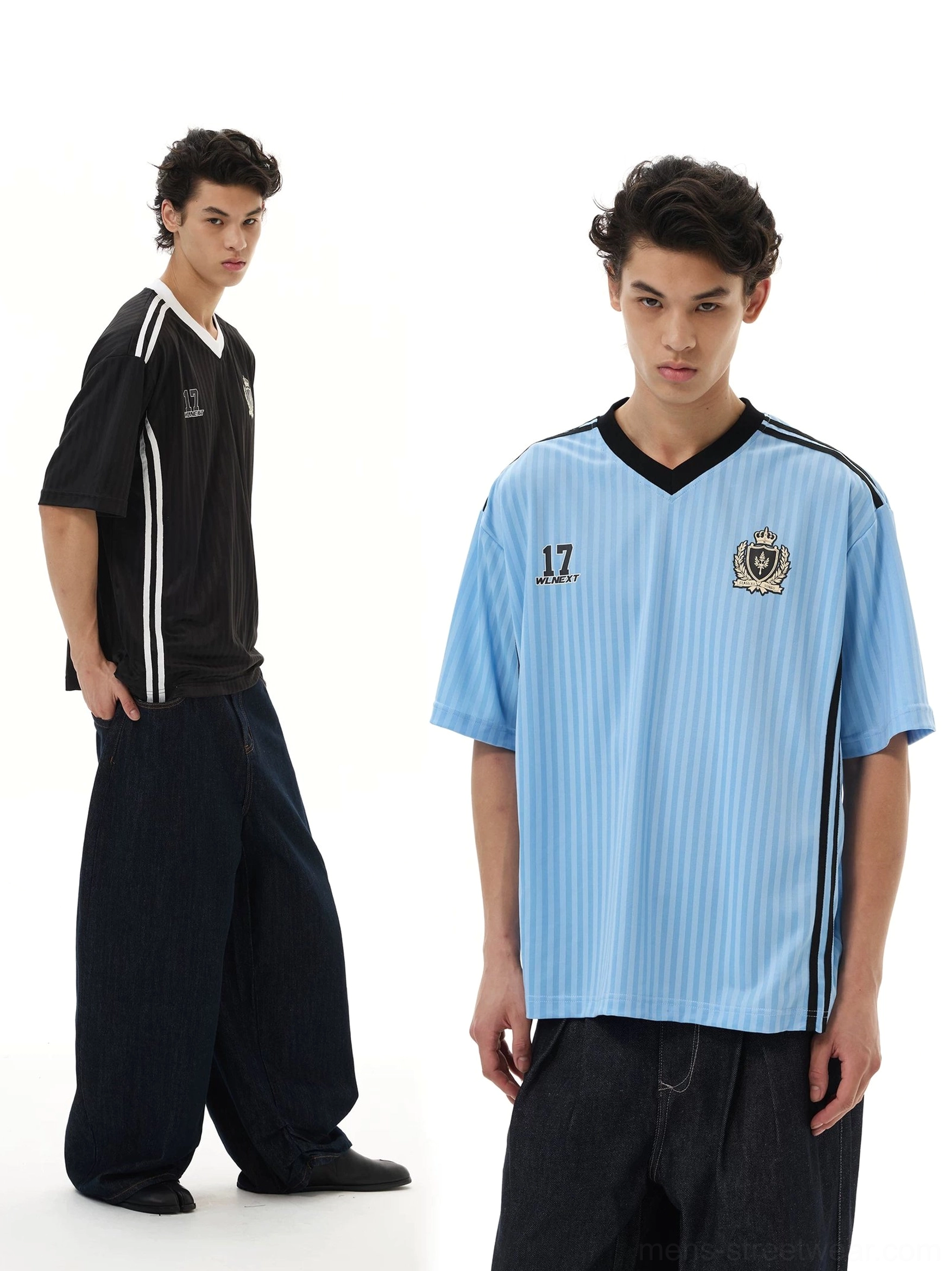 Light blue and black crested soccer jersey tees shown on male models with vertical pinstripes, V-neck collars, and wide-leg dark jeans