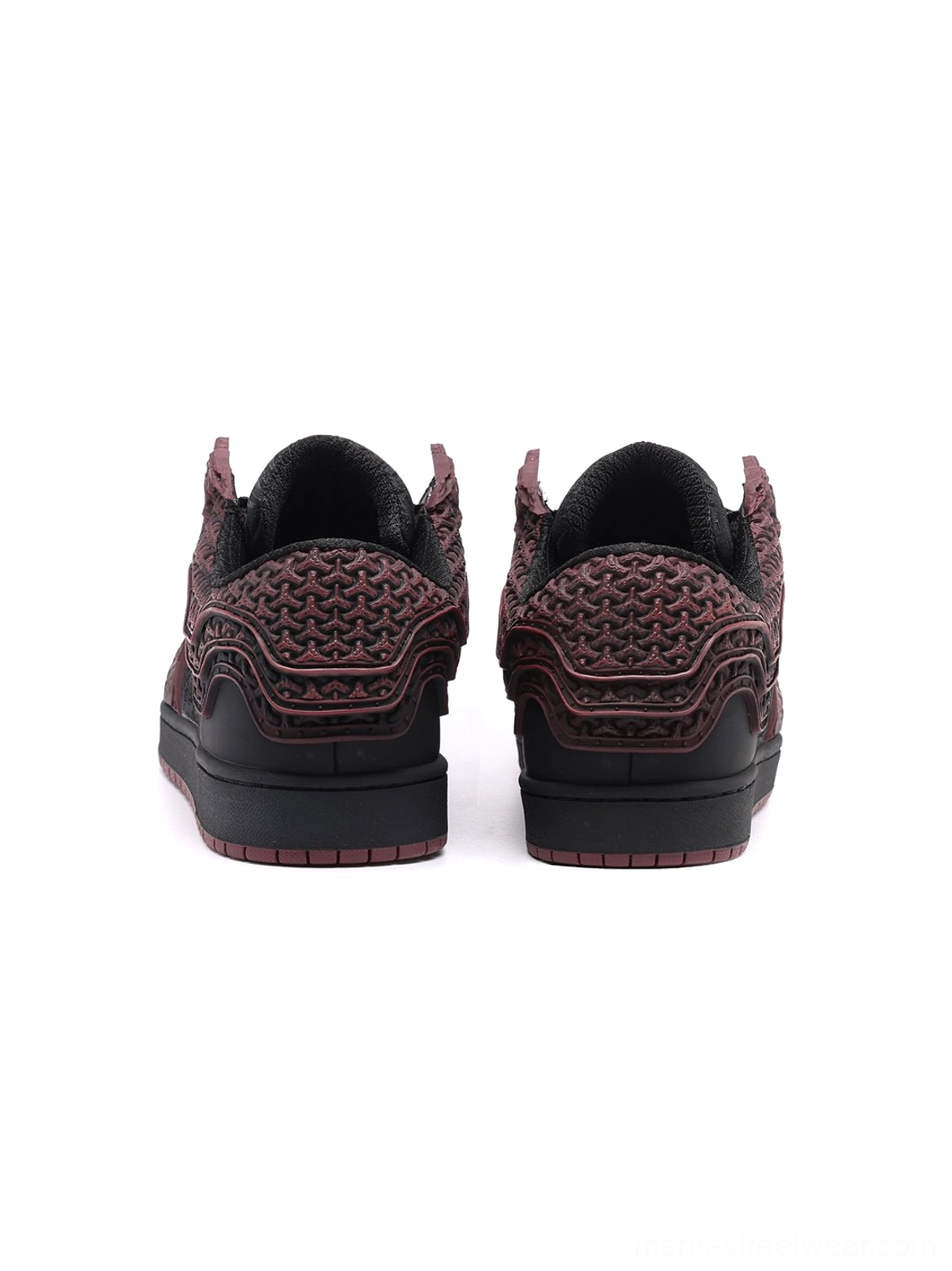 Rear view of crimson and black low-top streetwear sneakers with embossed relief patterns across the heel counters