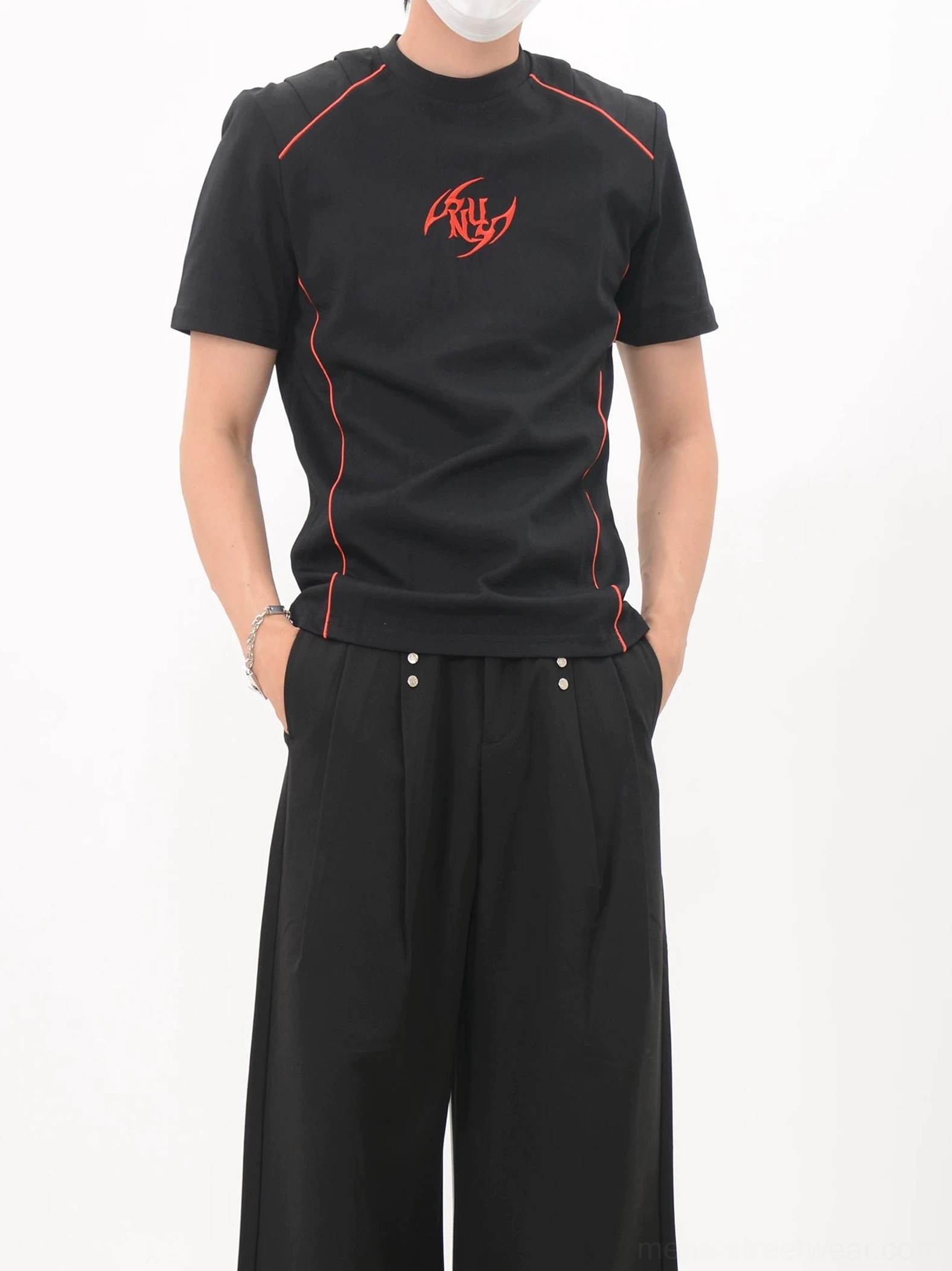 Black slim-fit racing-style T-shirt shown from the side front with curved red contrast piping and tailored streetwear cut