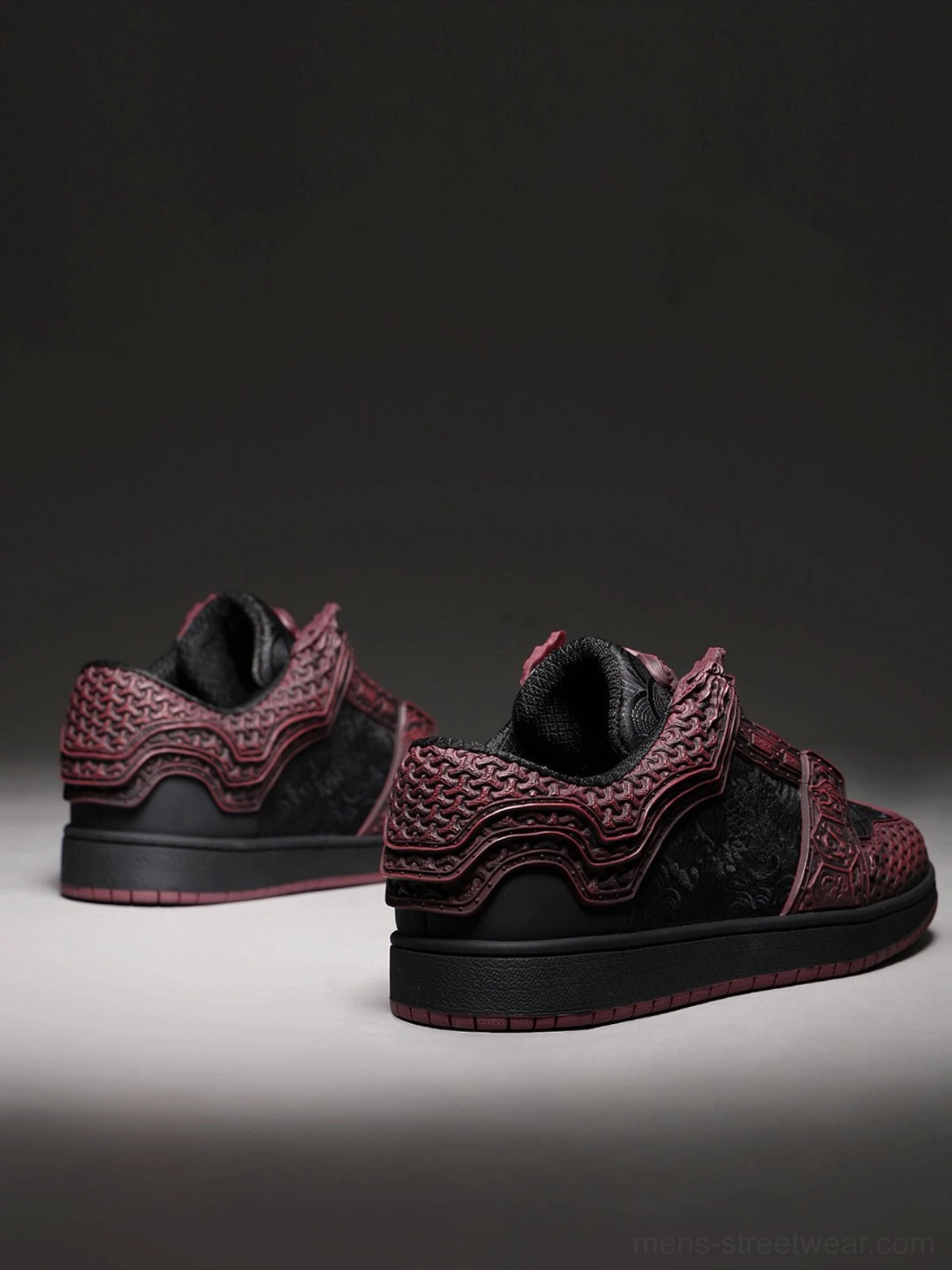 Crimson embossed low-top court sneakers with dark sole and sculptural relief design for modern streetwear wardrobes