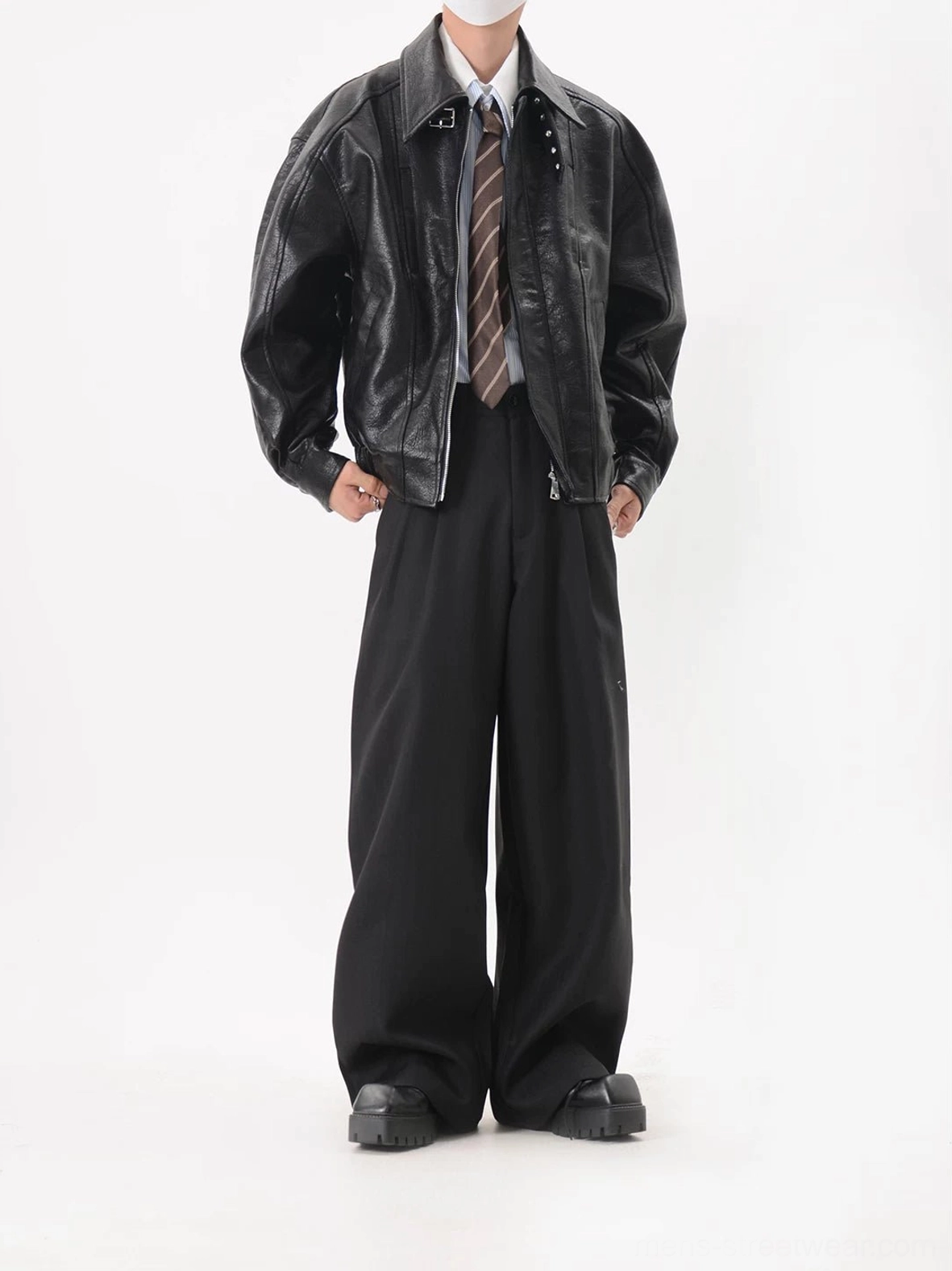 Black cropped oversized faux leather bomber jacket in right three-quarter view featuring dropped shoulders and panelled construction