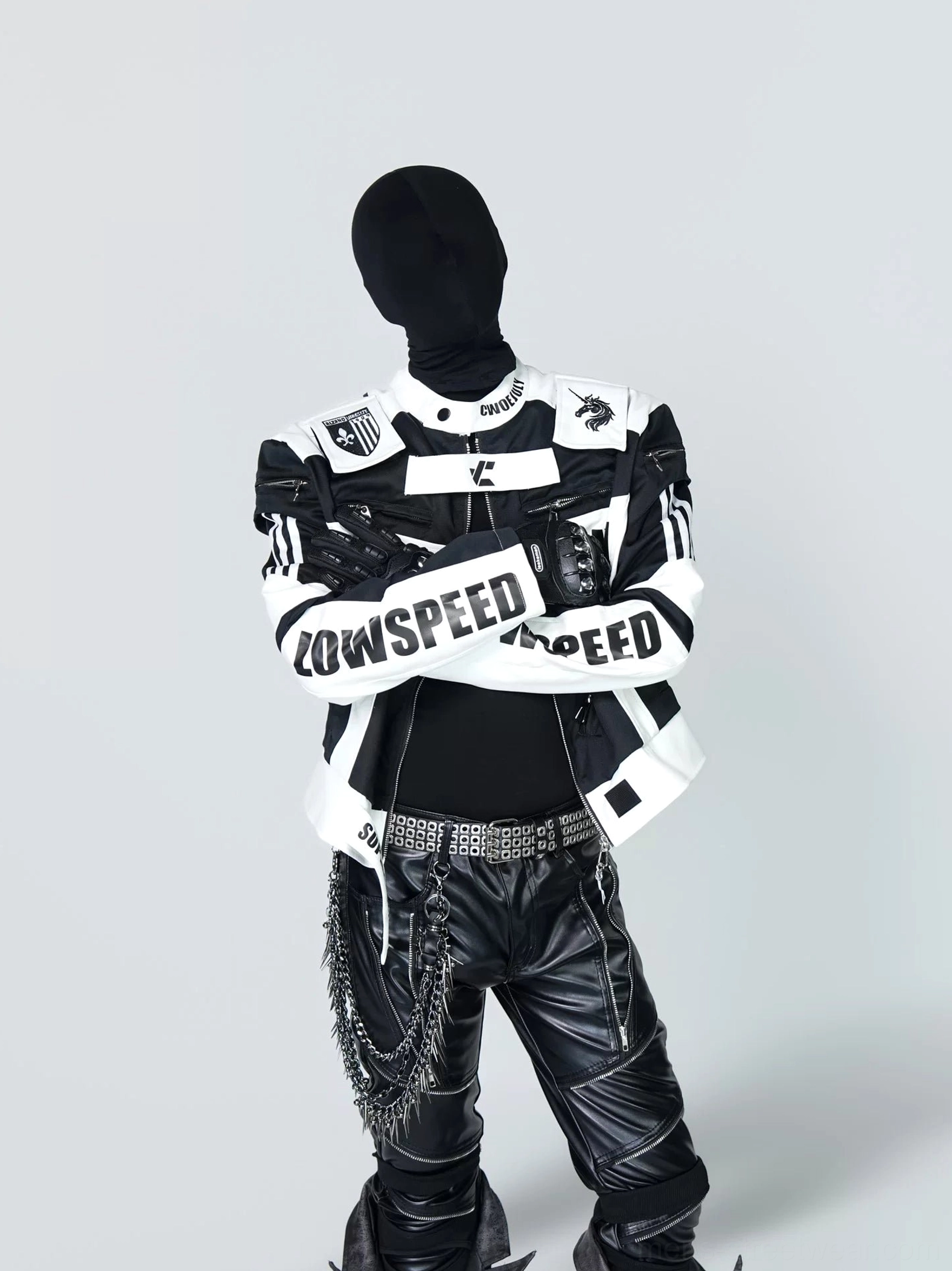 Cropped black and white racing style streetwear jacket front view with graphic sleeve panels and structured stand collar