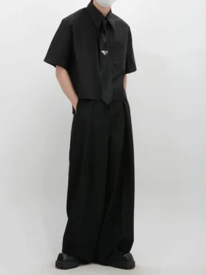 Back view of black cropped boxy short sleeve shirt with relaxed wide sleeves and tailored Seoul fashion silhouette