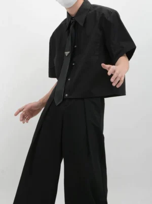 Black cropped boxy short sleeve shirt styled with wide leg trousers in a Seoul streetwear outfit side view