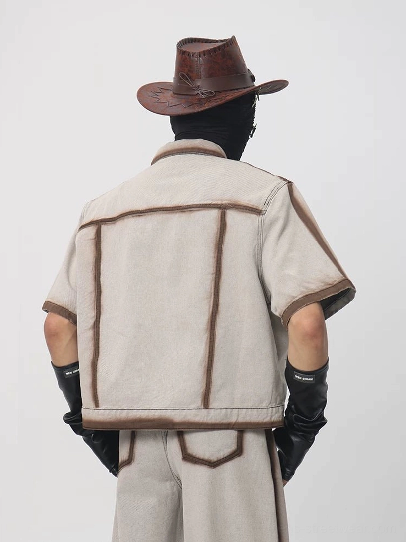 Back view of a cropped short sleeve denim workwear jacket showing the structured back yoke brown edge trim and boxy silhouette