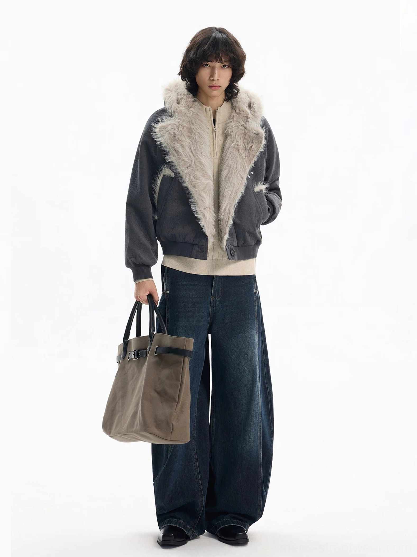 Dark gray cropped faux fur bomber jacket styled with wide leg jeans leather shoes and tote bag in a streetwear outfit