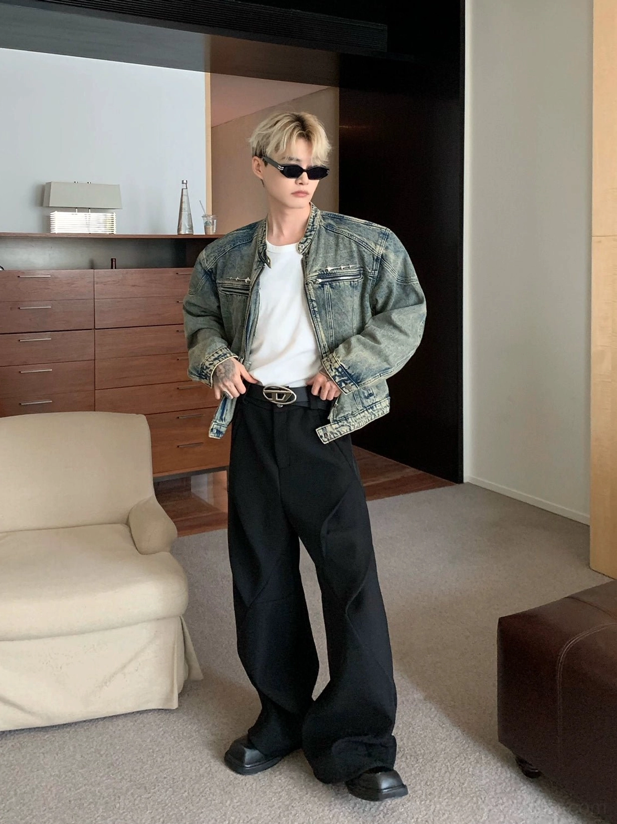 Distressed blue cropped stand collar denim moto jacket styled with black wide leg trousers