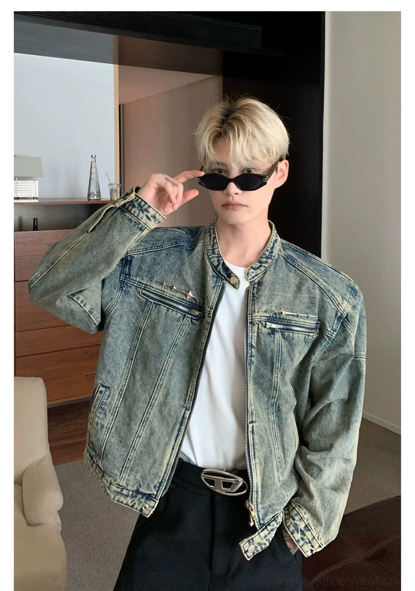 Distressed blue washed denim moto jacket side front view highlighting cropped structured silhouette