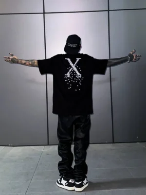 Back full-body view of a relaxed oversized Pixel X graphic streetwear T-shirt with large scattered digital X artwork and casual skate styling
