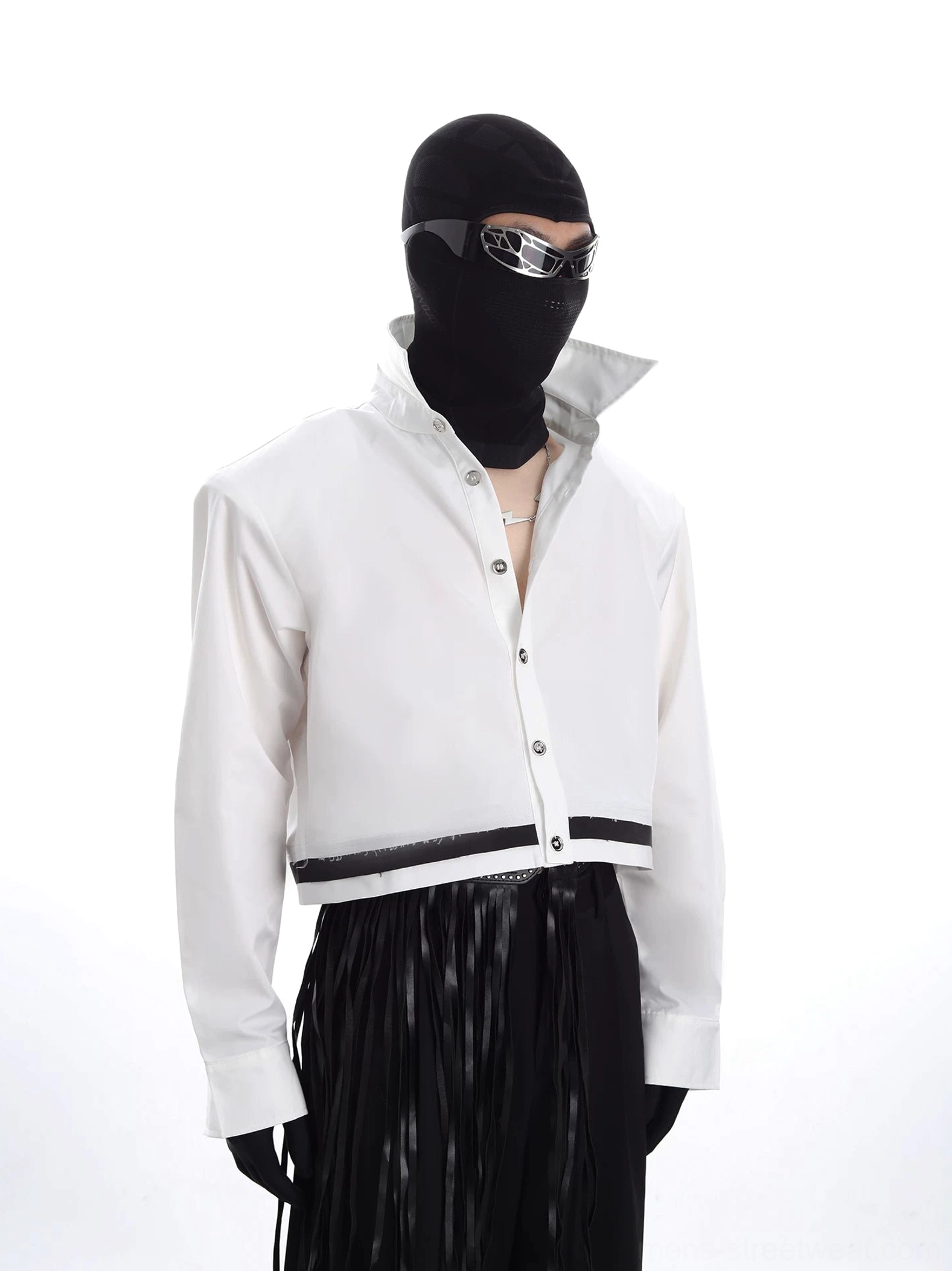 Three-quarter view of a white oversized cropped jacket with futuristic stand collar, long cuffed sleeves, clean front closure, and black contrast hem detail