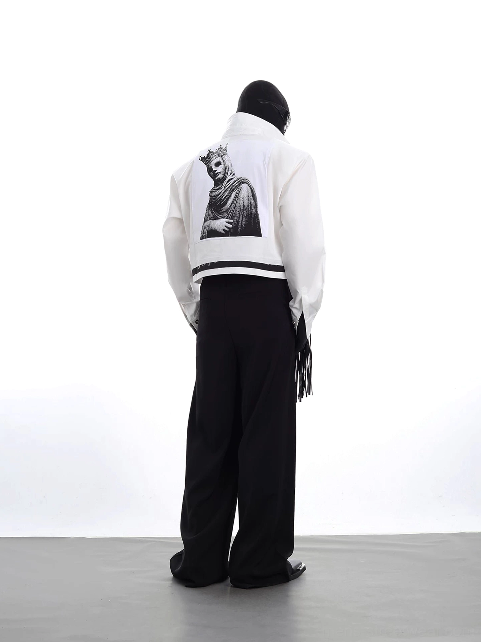 Rear view of a white cropped avant-garde jacket featuring a large crowned royal portrait graphic, black contrast hem stripe, and oversized streetwear fit