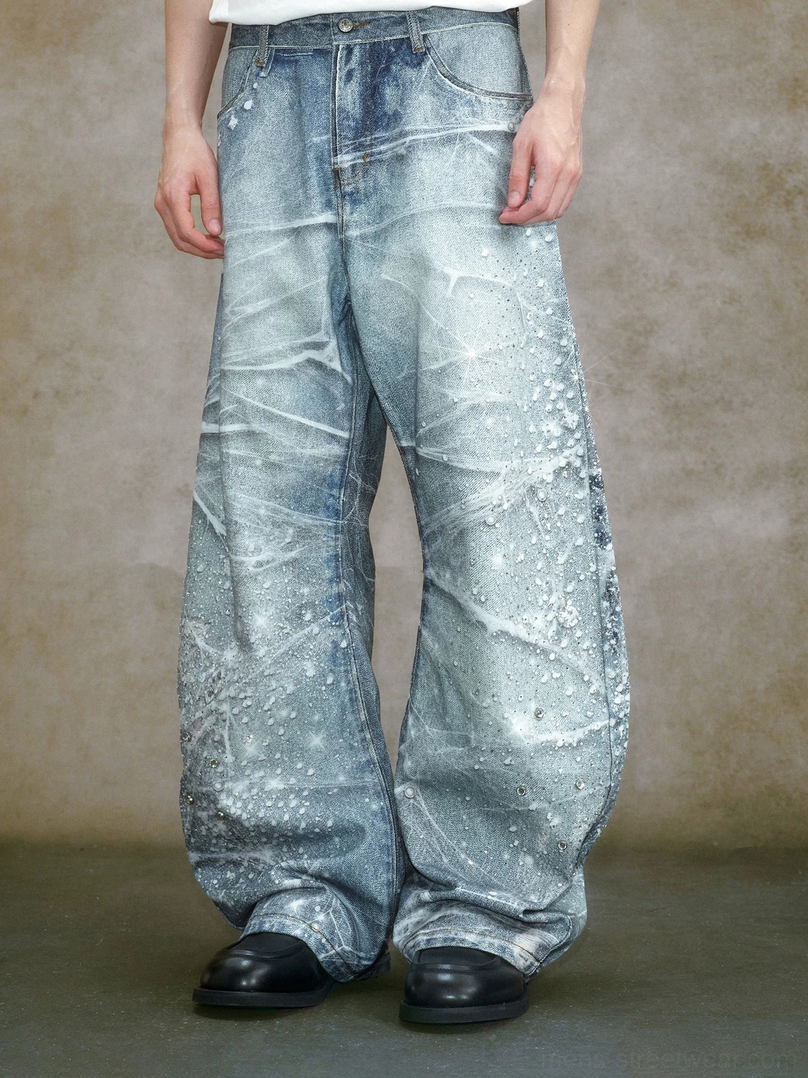 Front view of crystal embellished bleached wide leg jeans featuring high-rise waistband, classic front pockets, faded blue denim, and dramatic oversized legs