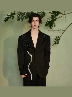 Front view of a black oversized blazer with silver crystal vine trim and floral sequin embellishments on the lapels