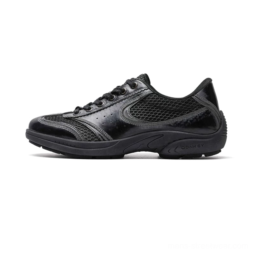 Retro black CurveLine court sneakers with breathable mesh panels, glossy black overlays, and full black rubber outsole