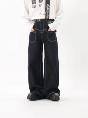 Dark blue contrast stitch wide leg utility jeans front view with oversized patch pockets and black platform shoes