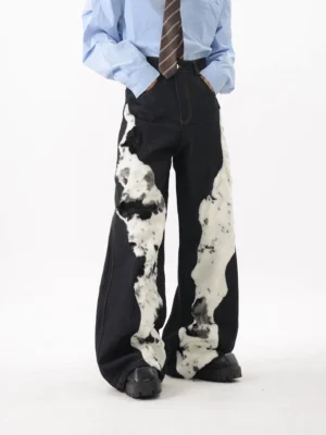 Dark blue faux fur panel denim trousers styled with a shirt and tie, showing wide leg silhouette and chunky shoe stacking