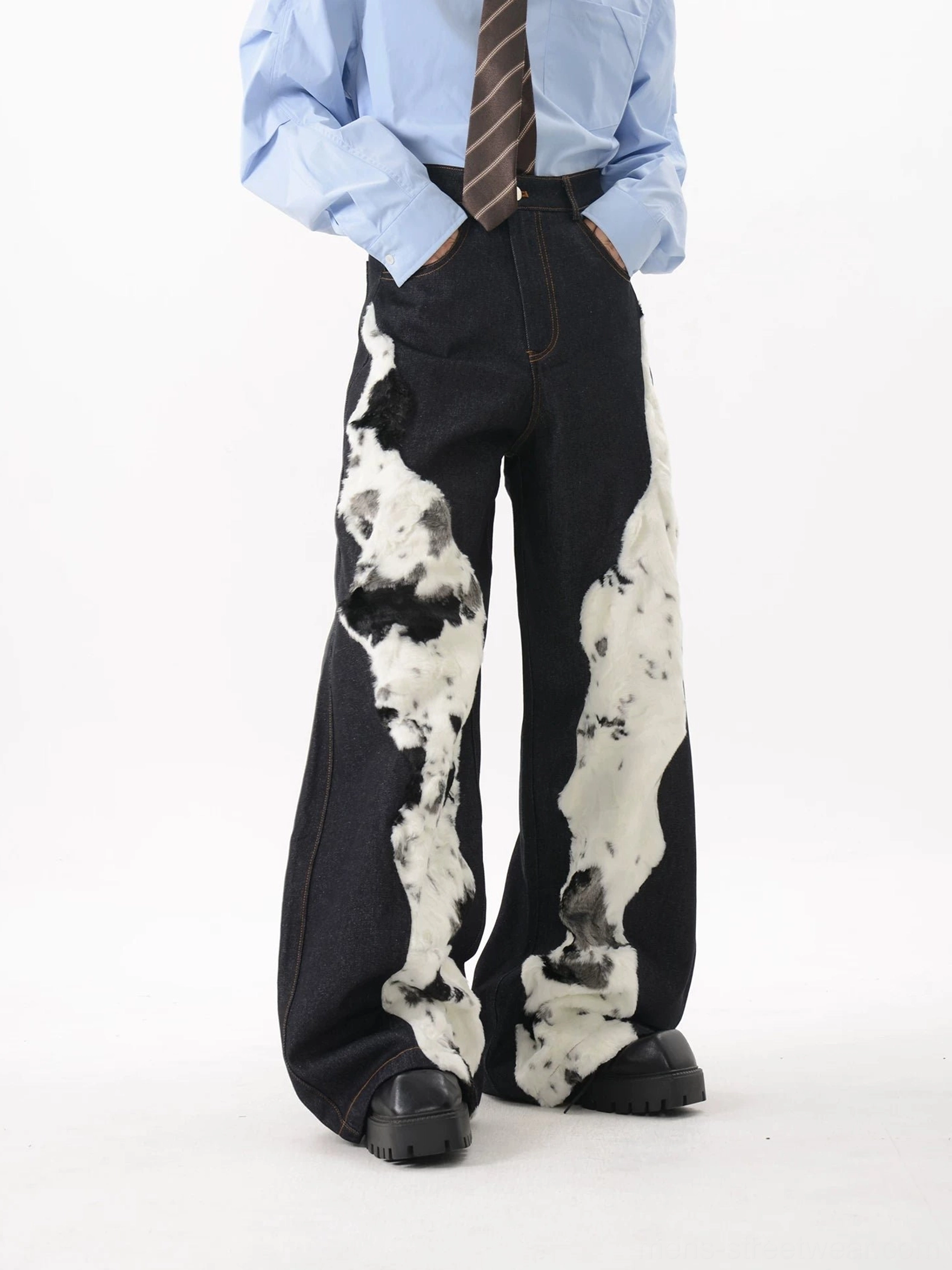 Dark blue faux fur panel denim trousers styled with a shirt and tie, showing wide leg silhouette and chunky shoe stacking