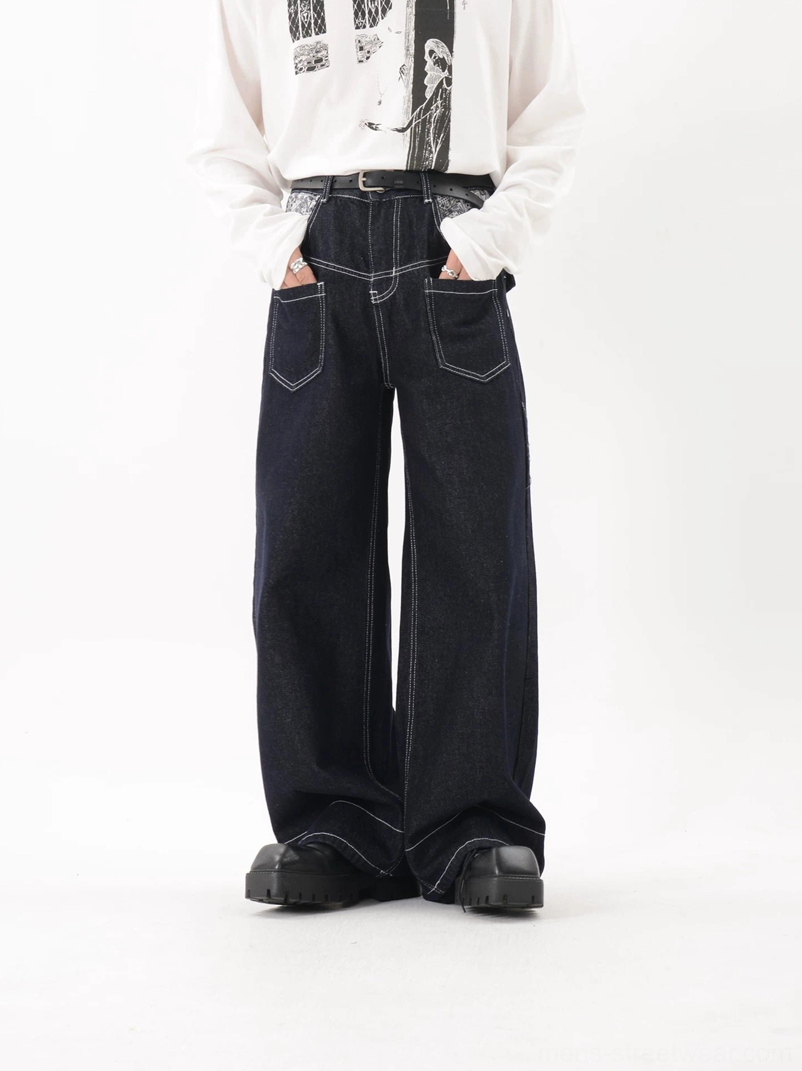 Dark blue indigo wide leg contrast stitch jeans with large front patch pockets and relaxed streetwear silhouette