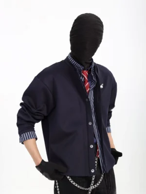 Dark blue minimal snap front cardigan jacket worn with a striped shirt, red tie, and chain detail in a Korean streetwear outfit