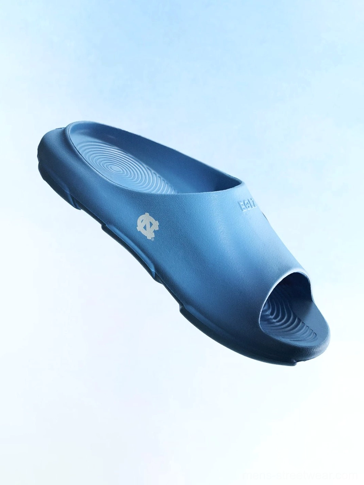 Dark blue molded open-toe slides with sculpted side panels, wave-textured footbed, and slip-on design