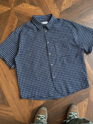 Dark blue oversized plaid short sleeve button shirt with micro check pattern styled in Korean streetwear fashion