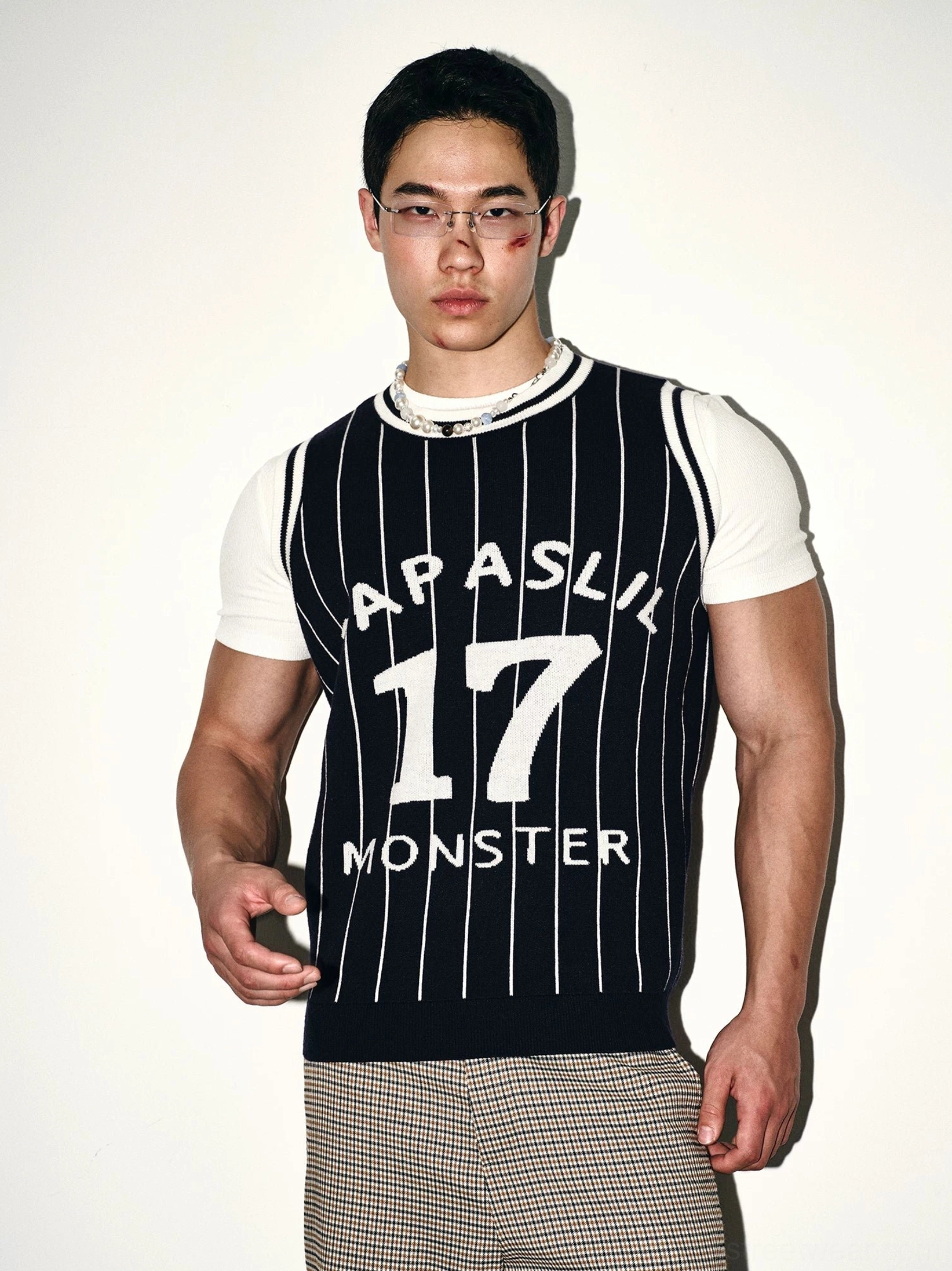 Straight-on front view of dark blue pinstripe knit basketball jersey vest with varsity lettering number 17 graphic and white trim