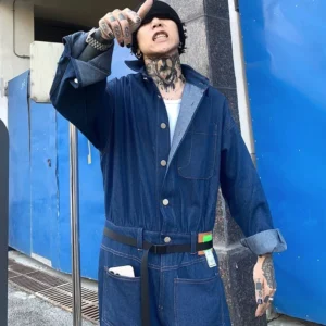 Dark blue relaxed denim workwear jumpsuit front view with button closure adjustable waist belt rolled cuffs and chest patch pocket