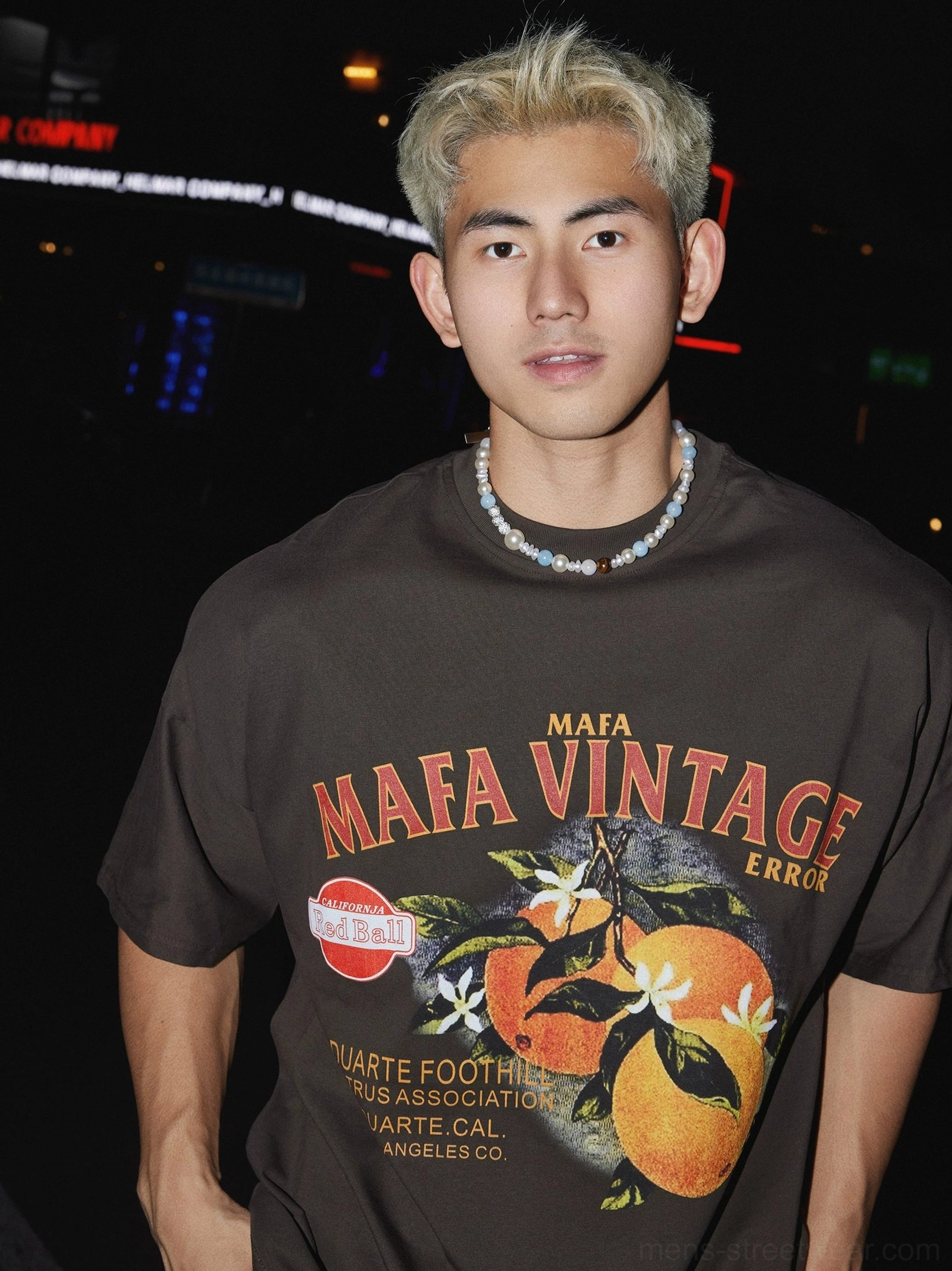 Dark brown cotton vintage citrus graphic T-shirt with distressed chest artwork styled with beaded necklace in Seoul-inspired street fashion