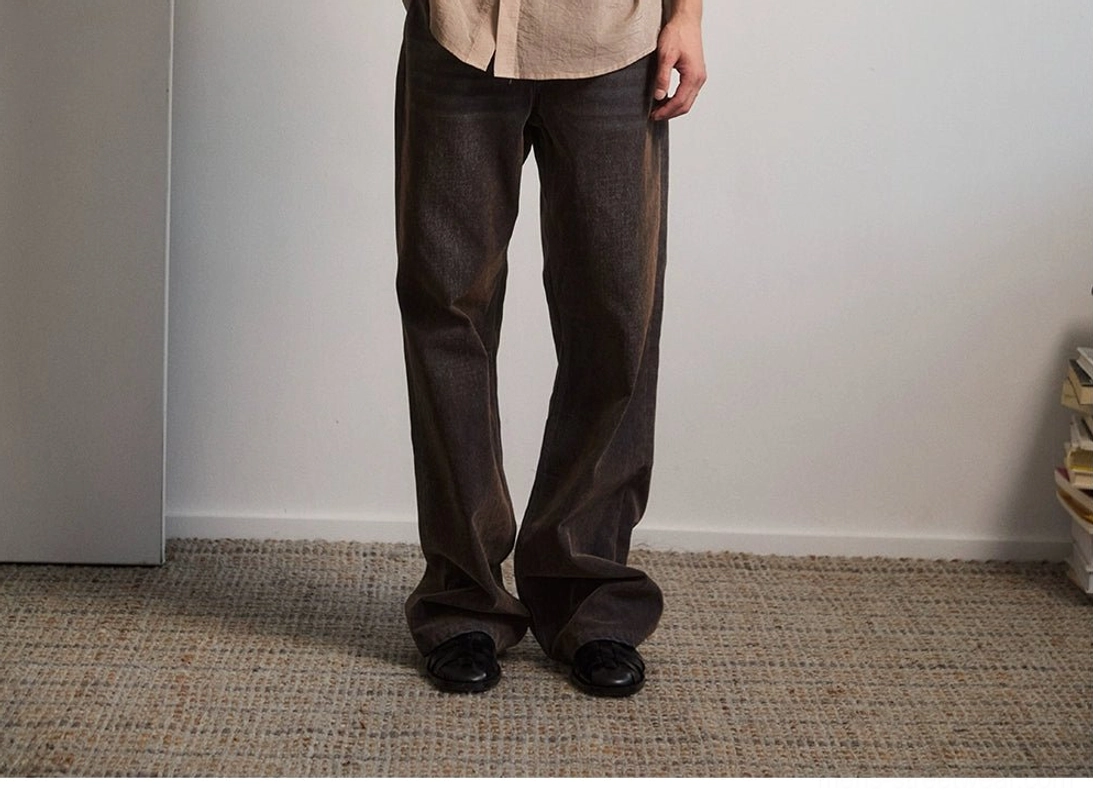 Dark brown flare denim jeans side lower body view showing streamlined high rise flare silhouette