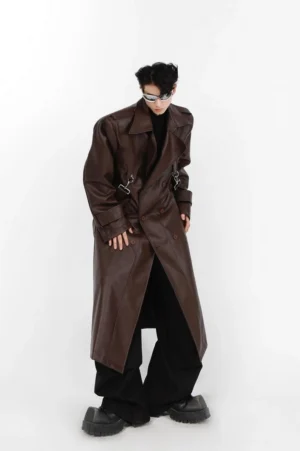 Dark brown long vegan leather trench coat shown from the front with oversized relaxed fit double chest clasps floor length hem and modern Seoul streetwear styling