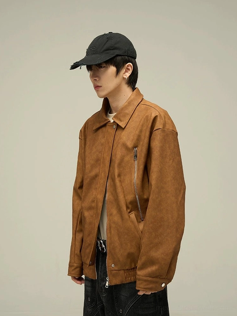 Side profile of a dark brown oversized faux leather jacket with relaxed Korean streetwear fit, classic collar, and subtle side zipper pocket detail