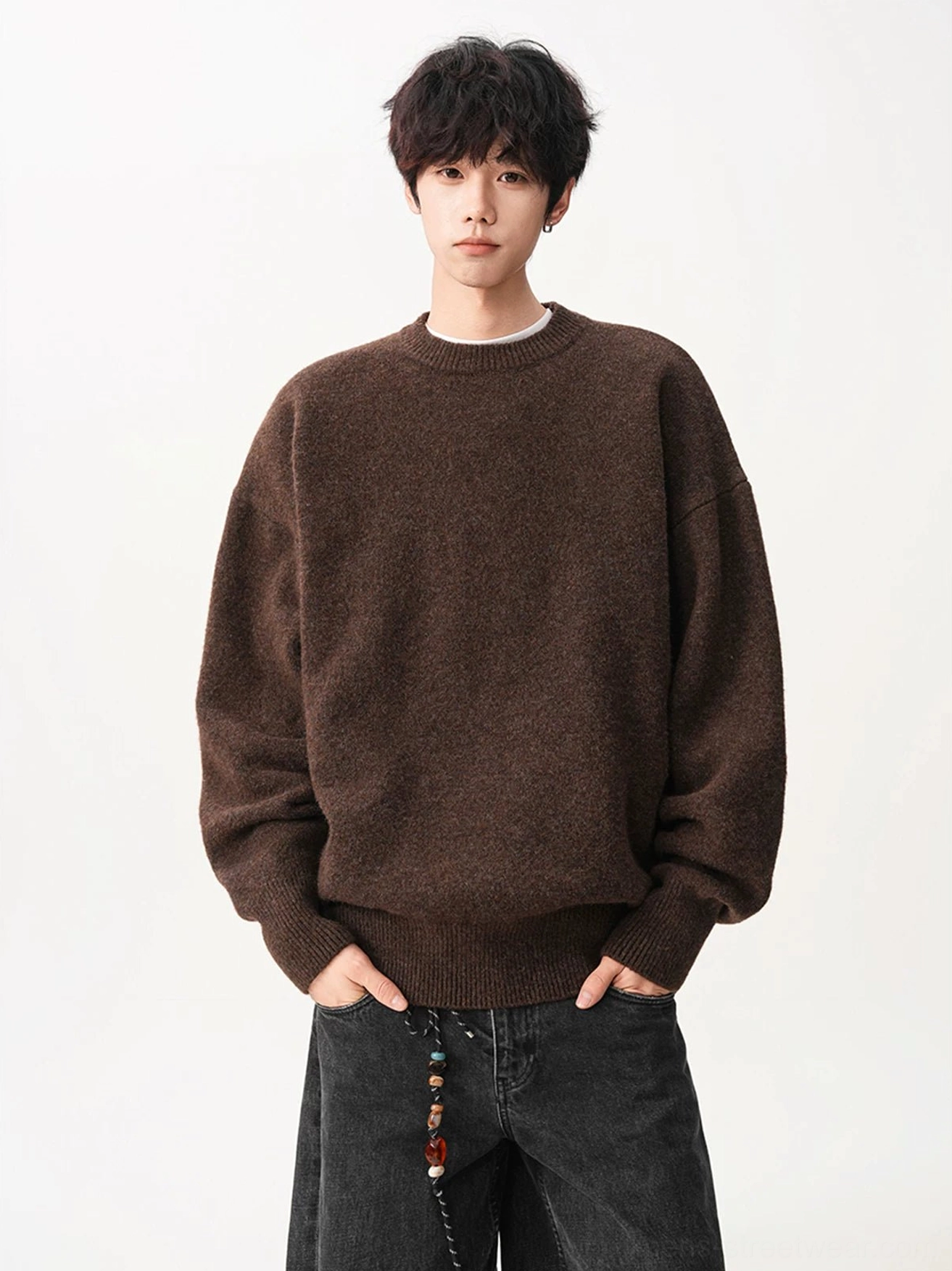 Dark brown oversized knit sweater with marled fuzzy texture, relaxed drop shoulder fit, and ribbed trims styled for modern Korean streetwear