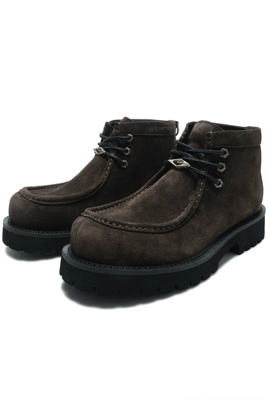 Dark brown shearling moc toe lug boots with classic moc stitching, metal lace hardware, and heavy black tread sole